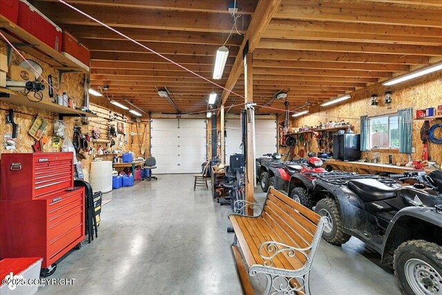64320 Trail Rd, Anchor Point, AK 99556 - garage featuring a workshop area and freestanding refrigerator