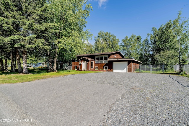 312 W Riverview Ave, Soldotna, AK 99669 - view of front of house with a garage and asphalt driveway