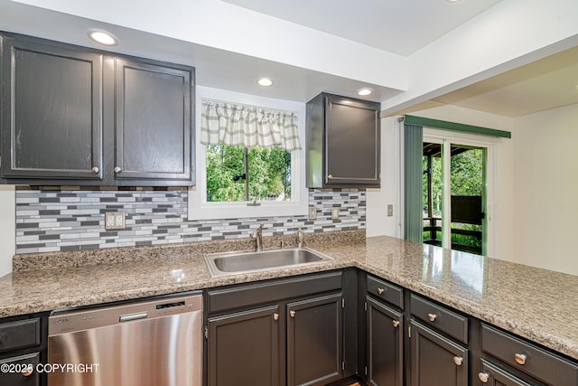 312 W Riverview Ave, Soldotna, AK 99669 - kitchen with stainless steel dishwasher, backsplash, recessed lighting, a peninsula, and light stone counters
