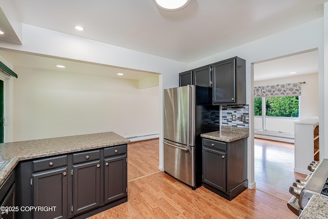 312 W Riverview Ave, Soldotna, AK 99669 - kitchen with baseboard heating, freestanding refrigerator, range, light wood-style flooring, and recessed lighting