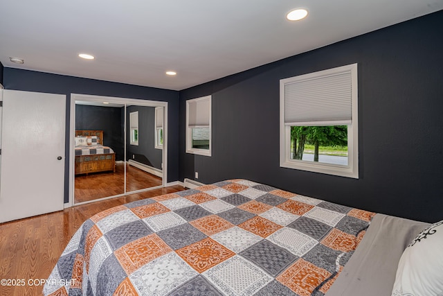 312 W Riverview Ave, Soldotna, AK 99669 - bedroom with a baseboard radiator, wood finished floors, recessed lighting, and a closet
