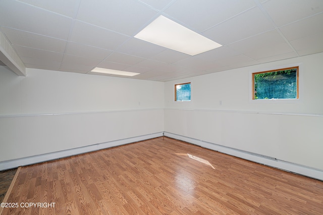 312 W Riverview Ave, Soldotna, AK 99669 - spare room featuring wood finished floors, a paneled ceiling, and a baseboard heating unit