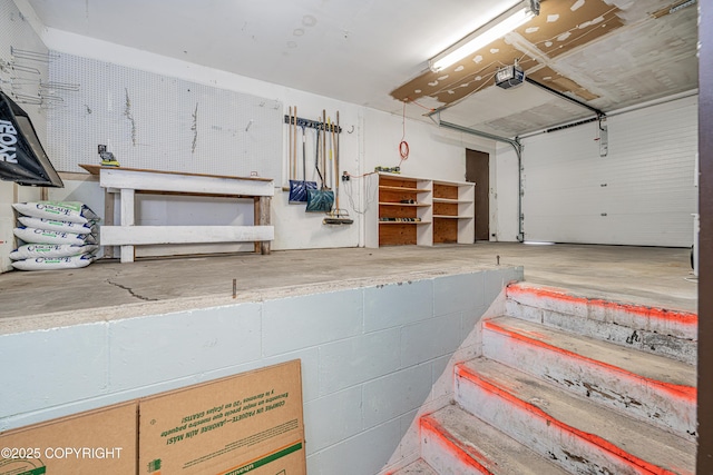 312 W Riverview Ave, Soldotna, AK 99669 - garage with a workshop area and a garage door opener