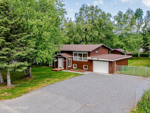 312 W Riverview Ave, Soldotna, AK 99669 - view of front of property featuring driveway, a shingled roof, a garage, and a gate