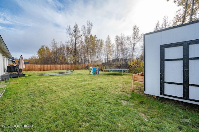 1302 E Esty Dr, Palmer, AK 99645 - fenced backyard with a trampoline and a storage unit
