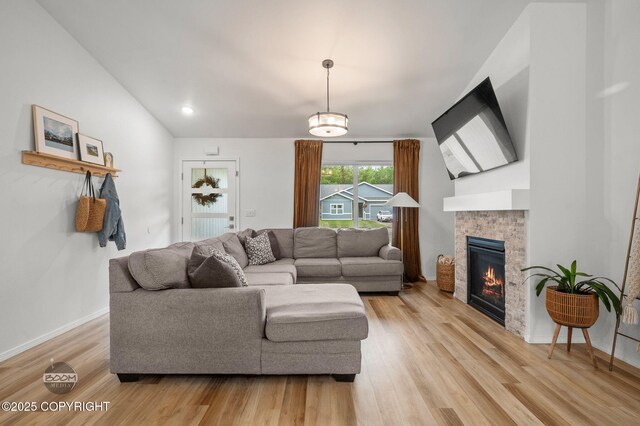 1302 E Esty Dr, Palmer, AK 99645 - living area with light wood-style flooring, vaulted ceiling, and a glass covered fireplace