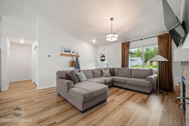 1302 E Esty Dr, Palmer, AK 99645 - living room featuring vaulted ceiling, light wood-style flooring, and a fireplace