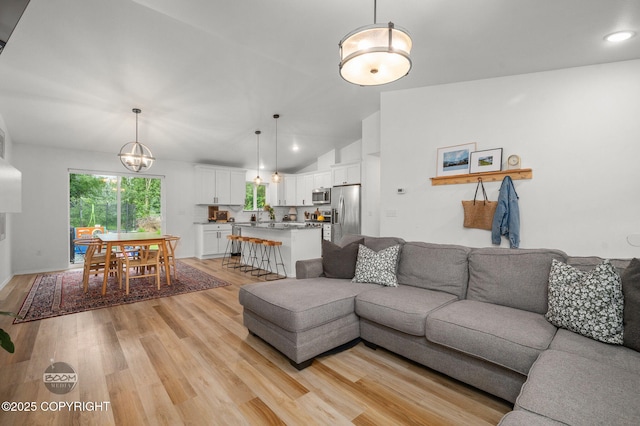 1302 E Esty Dr, Palmer, AK 99645 - living area with light wood-style floors, lofted ceiling, recessed lighting, and a chandelier