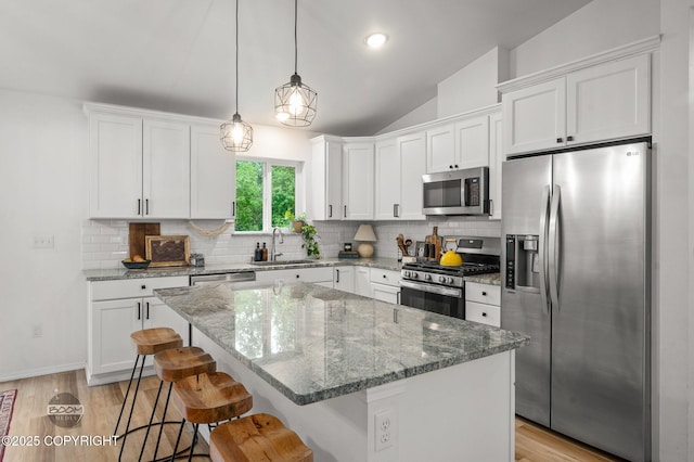1302 E Esty Dr, Palmer, AK 99645 - kitchen with appliances with stainless steel finishes, white cabinetry, backsplash, and vaulted ceiling