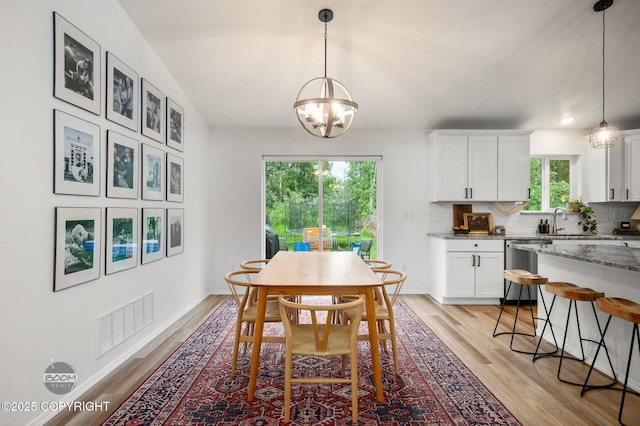 1302 E Esty Dr, Palmer, AK 99645 - dining space with light wood-style flooring and a chandelier