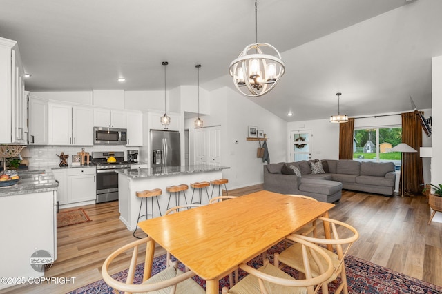 1302 E Esty Dr, Palmer, AK 99645 - dining area featuring lofted ceiling, a chandelier, light wood-style flooring, and recessed lighting