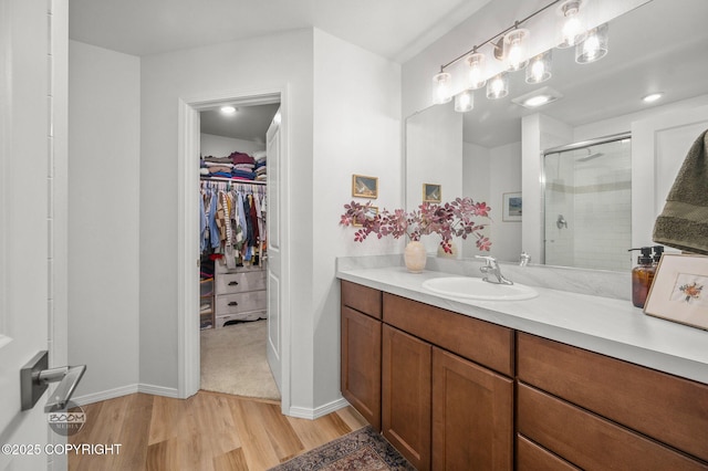 1302 E Esty Dr, Palmer, AK 99645 - full bath featuring wood finished floors, a shower stall, vanity, and a spacious closet