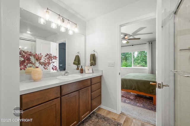 1302 E Esty Dr, Palmer, AK 99645 - ensuite bathroom featuring vanity, wood finished floors, ceiling fan, and tiled shower
