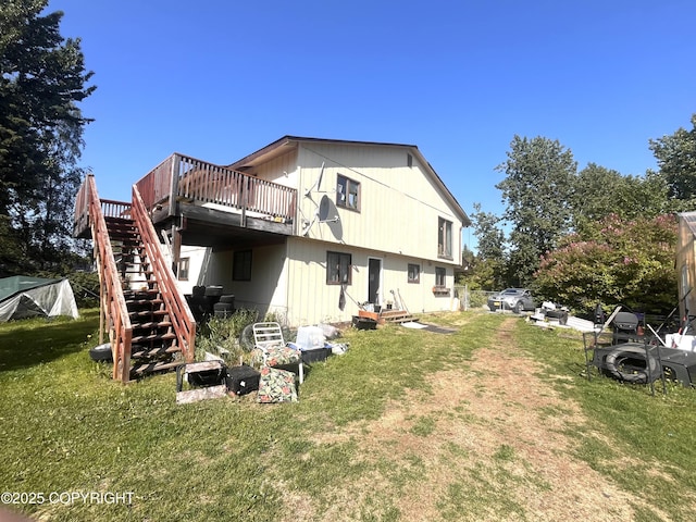 4002 Barbara Dr, Anchorage, AK 99517 - back of property featuring stairway, a wooden deck, and a lawn