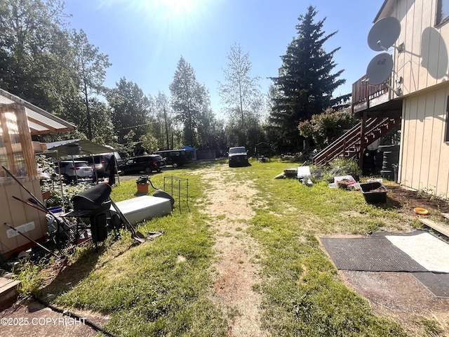 4002 Barbara Dr, Anchorage, AK 99517 - view of green lawn with stairway and view of scattered trees