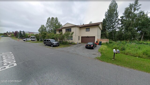 4002 Barbara Dr, Anchorage, AK 99517 - view of front of house featuring driveway and a garage
