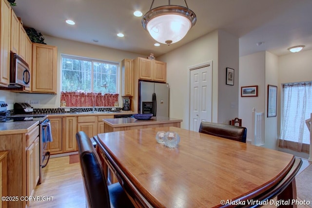 20103 Riverside Dr # 1B, Eagle River, AK 99577 - kitchen featuring appliances with stainless steel finishes, light brown cabinetry, a kitchen island, light wood-style flooring, and recessed lighting