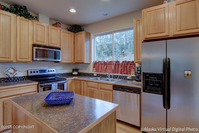 20103 Riverside Dr # 1B, Eagle River, AK 99577 - kitchen featuring stainless steel appliances, light brown cabinetry, dark countertops, recessed lighting, and a kitchen island