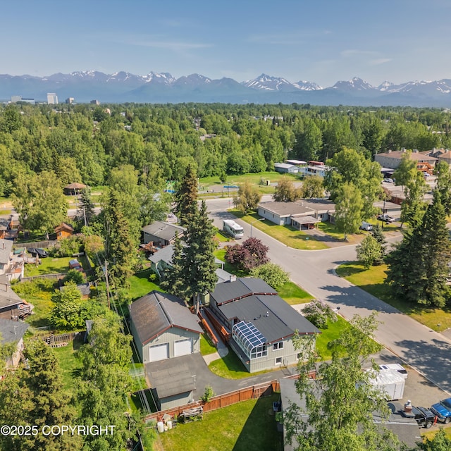 2831 Bennett Ave, Anchorage, AK 99517 - aerial perspective of suburban area featuring a mountainous background and a forest