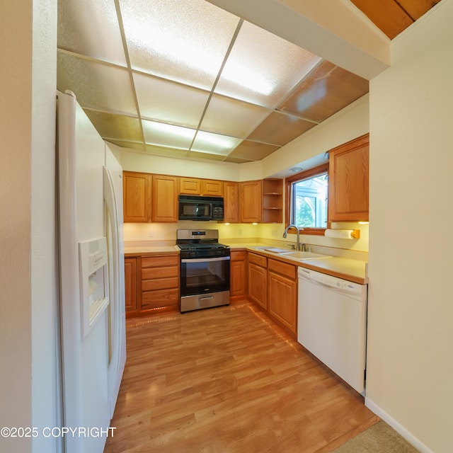 2831 Bennett Ave, Anchorage, AK 99517 - kitchen featuring white appliances, light wood-style floors, light countertops, open shelves, and brown cabinetry