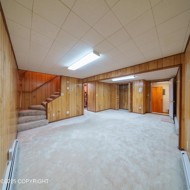 2831 Bennett Ave, Anchorage, AK 99517 - finished basement with a baseboard radiator, wooden walls, stairs, and carpet floors