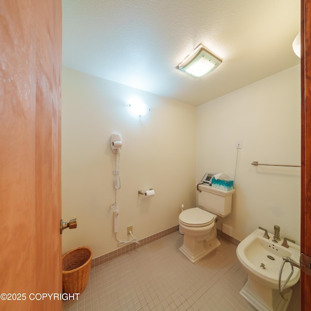 2831 Bennett Ave, Anchorage, AK 99517 - bathroom featuring a bidet and tile patterned flooring