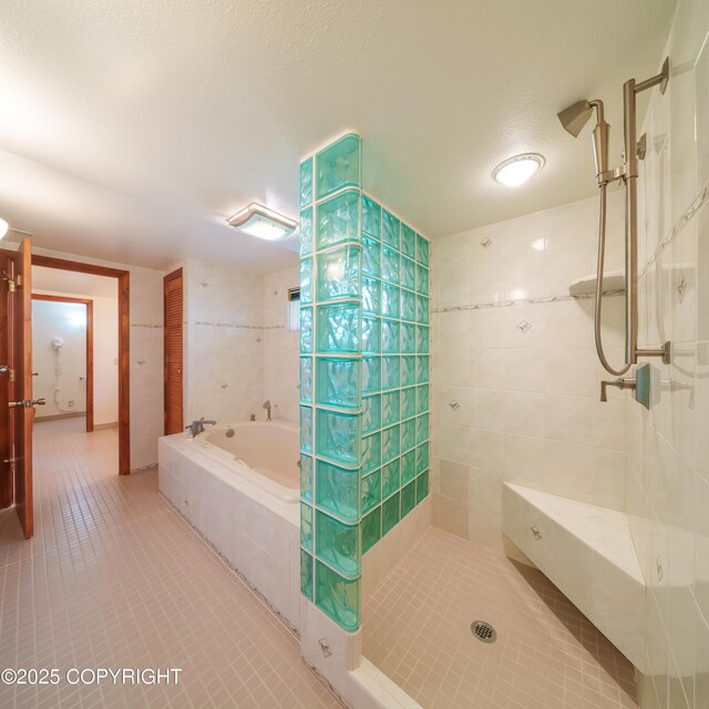 2831 Bennett Ave, Anchorage, AK 99517 - full bathroom with tile patterned floors, a garden tub, tiled shower, and tile walls