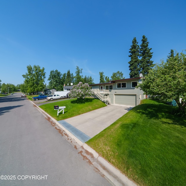 2831 Bennett Ave, Anchorage, AK 99517 - view of front of house featuring a garage, driveway, a front lawn, and stairs