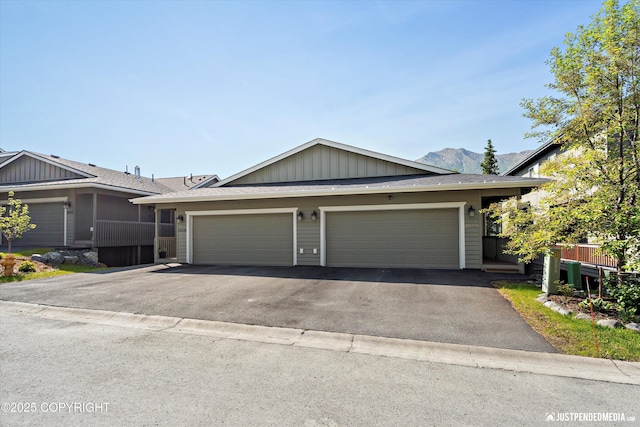 20218 Eagles Nest Ct, Eagle River, AK 99577 - ranch-style house featuring driveway, a garage, board and batten siding, roof with shingles, and a mountain view