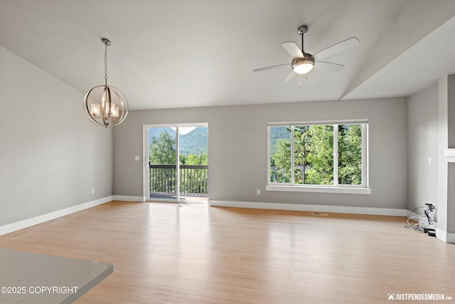 20218 Eagles Nest Ct, Eagle River, AK 99577 - empty room with vaulted ceiling, a chandelier, ceiling fan, and light wood-style flooring