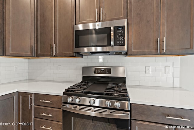 20218 Eagles Nest Ct, Eagle River, AK 99577 - kitchen featuring stainless steel appliances, dark brown cabinetry, light countertops, and tasteful backsplash