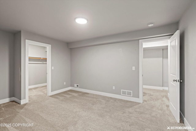 20218 Eagles Nest Ct, Eagle River, AK 99577 - unfurnished bedroom with light carpet, a spacious closet, and a closet