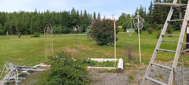48105 Halverson Ave, Soldotna, AK 99669 - view of grassy yard featuring a vegetable garden