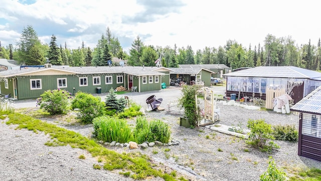 48105 Halverson Ave, Soldotna, AK 99669 - rear view of house featuring a greenhouse and an outbuilding