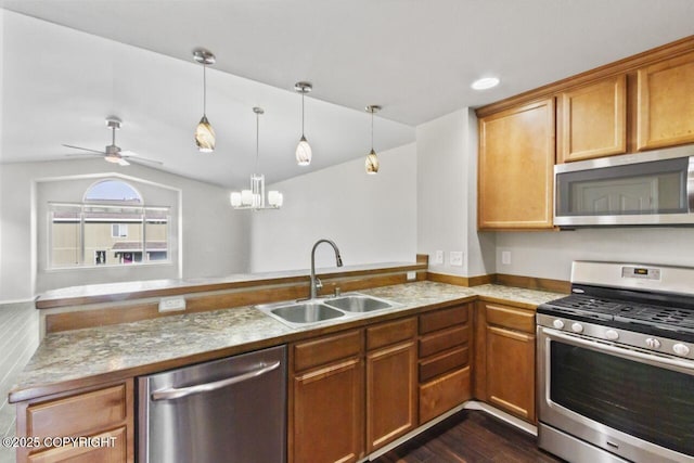 6218 Ophir Dr, Anchorage, AK 99504 - kitchen with stainless steel appliances, vaulted ceiling, a peninsula, decorative light fixtures, and a chandelier