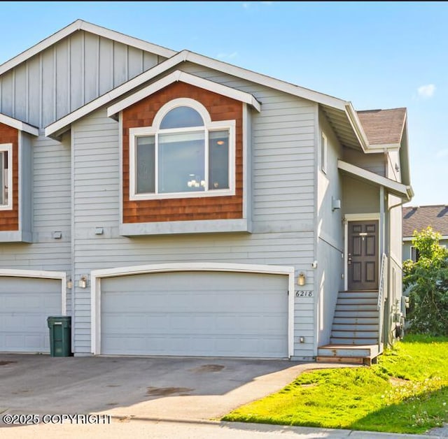 6218 Ophir Dr, Anchorage, AK 99504 - view of front of house with an attached garage, concrete driveway, and board and batten siding