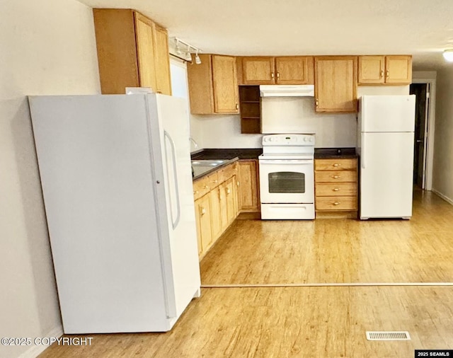 6590 Glacier Hwy, Juneau, AK 99801 - kitchen featuring white appliances, dark countertops, light wood finished floors, and under cabinet range hood