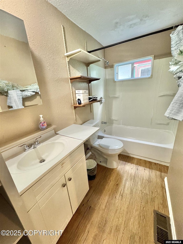 6590 Glacier Hwy, Juneau, AK 99801 - full bath with a textured wall, vanity, wood finished floors, tub / shower combination, and a textured ceiling