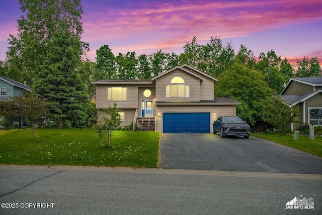 16540 Theodore Dr, Eagle River, AK 99577 - bi-level home featuring an attached garage, driveway, and a yard