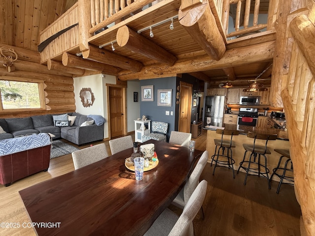 35605 Kalifornsky Beach Rd, Kenai, AK 99669 - dining room with a wooden ceiling with exposed beams, dark wood-type flooring, rustic walls, and rail lighting