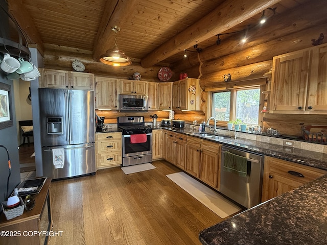 35605 Kalifornsky Beach Rd, Kenai, AK 99669 - kitchen with stainless steel appliances, log walls, dark wood-type flooring, dark stone counters, and a wooden ceiling with exposed beams