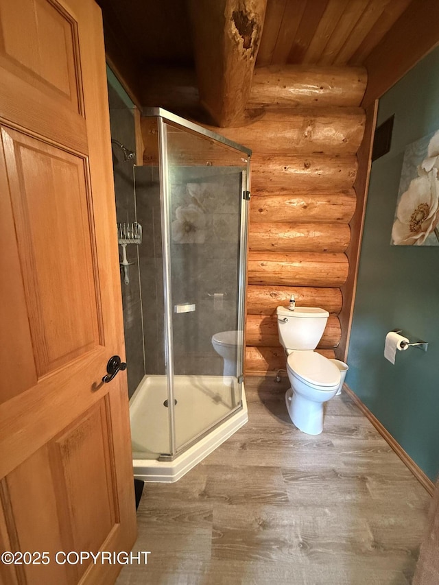 35605 Kalifornsky Beach Rd, Kenai, AK 99669 - bathroom with log walls, wood finished floors, a shower stall, and wood ceiling