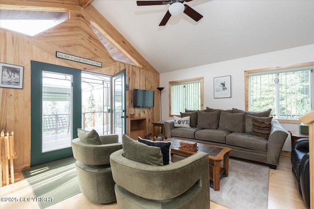 1685 Taroka Dr, Fairbanks, AK 99709 - living room featuring wooden walls, a ceiling fan, and light wood-type flooring
