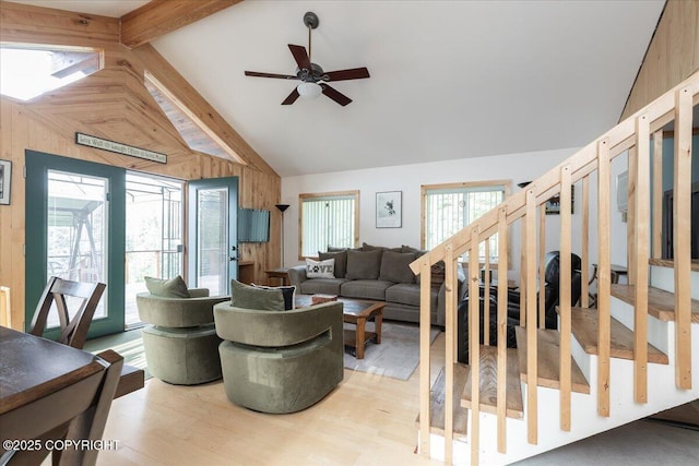 1685 Taroka Dr, Fairbanks, AK 99709 - living room featuring a ceiling fan, beam ceiling, high vaulted ceiling, wooden walls, and light wood-type flooring