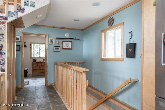 1685 Taroka Dr, Fairbanks, AK 99709 - hallway with plenty of natural light, dark stone finish flooring, crown molding, and an upstairs landing
