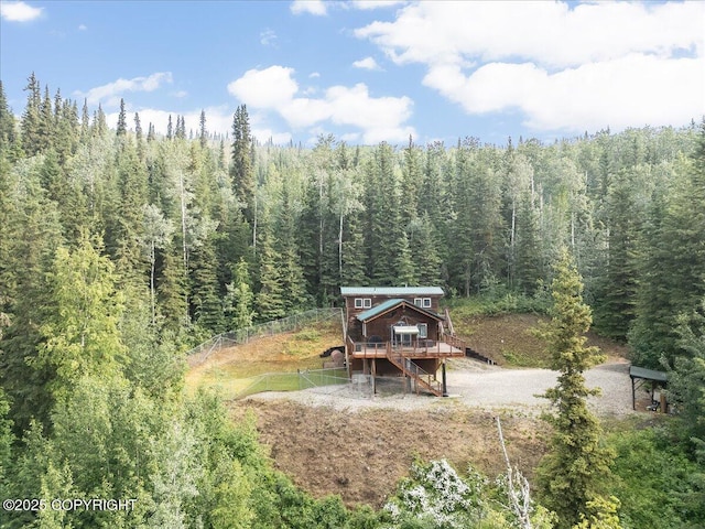 1685 Taroka Dr, Fairbanks, AK 99709 - view of yard with a view of trees, a deck, and stairway