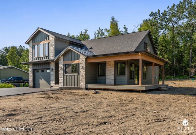 1401 E Holland Ave, Wasilla, AK 99654 - view of front facade featuring stone siding, a porch, board and batten siding, an attached garage, and concrete driveway
