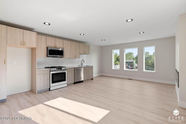 1401 E Holland Ave, Wasilla, AK 99654 - kitchen with stainless steel appliances, light brown cabinetry, light wood-style floors, decorative backsplash, and recessed lighting
