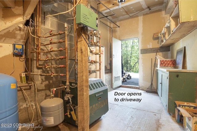 15021 Old Seward Hwy, Anchorage, AK 99516 - basement with a water pressure tank, strapped water heater, and a heating unit