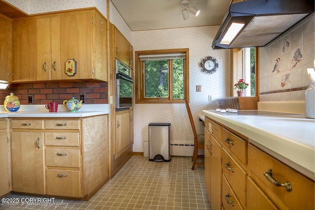 15021 Old Seward Hwy, Anchorage, AK 99516 - kitchen with wallpapered walls, wall chimney exhaust hood, oven, light countertops, and baseboard heating